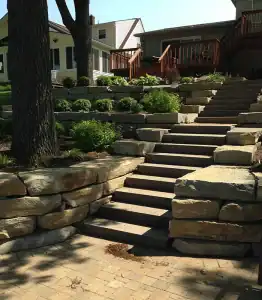 Natural stone step with retaining wall and plants