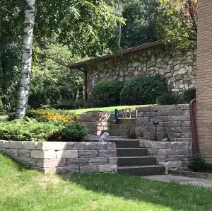 Outdoor stone staircase with landscaping and greenery.