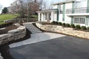 Paved driveway with natural stone retaining walls