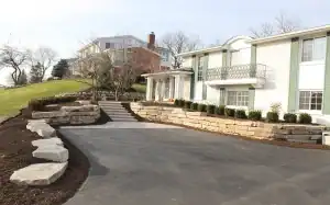 Paved driveway with natural stone retaining walls