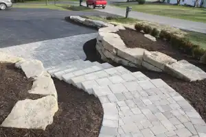 Paved driveway with natural stone retaining walls