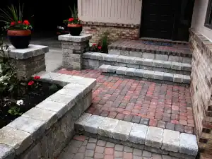 Red and gray paved steps and entryway.