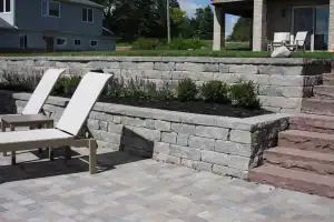 Patio and retaining wall paved with gray stones.