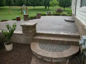 Paved block steps with decorative pattern paved patio.