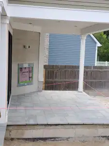Gray paved tiled patio under construction.