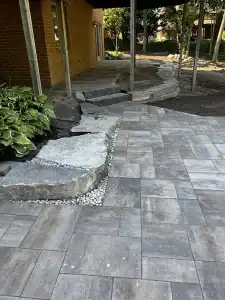 Outdoor patio with stone steps and landscaping for enhanced curb appeal.
