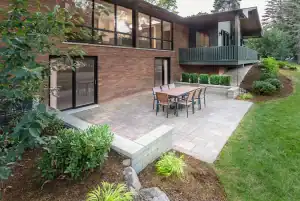 Modern outdoor patio with lush landscaping and spacious backyard.