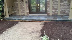 Entrance with stone pathway and landscaping.