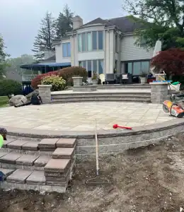 Outdoor patio with stone steps and landscaping.