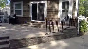 Beautifully designed outdoor patio with steps and railing.