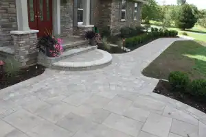 Beautiful stone paver walkway and landscaped garden at a residential home.