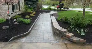 Outdoor garden pathway with stone pavers and landscaping.