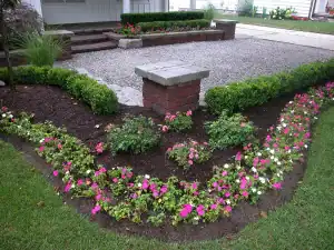 Outdoor garden landscaping with colorful flowers and neatly trimmed shrubs.
