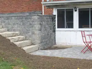 Natural stone steps with stone retaining wall.